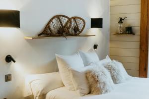 a bedroom with a white bed with white pillows at Hôtel Restaurant La Ferme de Cupelin in Saint-Gervais-les-Bains