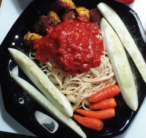 a black plate of food with noodles and vegetables at Captain Morgan House in Kingston