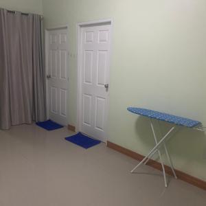 a room with two doors and a table with blue mats at Krabi Pool Villa Thailand in Ban Khlong Chi Lat