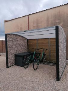 a bike parked next to a building with a garage at La caseta del canal in Deltebre