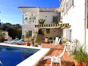a villa with a swimming pool and a house at Villa Mara in Caleta De Velez +36 photos