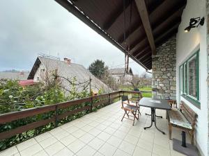 a patio with a table and chairs on a balcony at House Amalia in Bled +10 photos