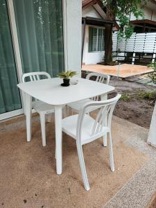a white table and chairs on a patio at Green Haven Villas in Krabi