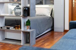 a bedroom with a bed and a table with a tv at Il Piccolo Etrusco-Centro Storico in Arezzo