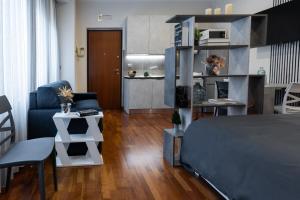 a bedroom with a bed and a living room at Il Piccolo Etrusco-Centro Storico in Arezzo