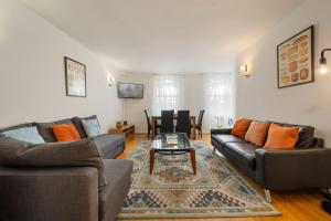 a living room with two couches and a table at The London Loftscape in London