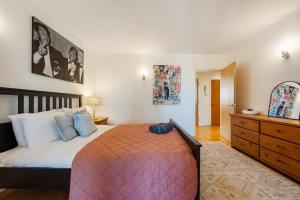 a bedroom with a large bed and a dresser at The London Loftscape in London