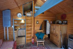 a log cabin with a kitchen and a living room at Chalet in paradise garden in Velden