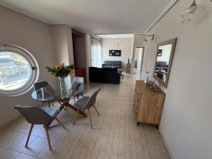 ein Wohnzimmer mit Tisch, Stühlen und Sofa in der Unterkunft Nook 37 in Nea Anchialos