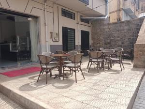 a group of tables and chairs on a patio at Hôtel Tlemcen médina in Tlemcen
