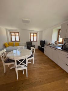 a kitchen and dining room with a table and chairs at Altes Winzerhaus in der Wachau - neu renoviertes Haus mit Terrasse in Dürnstein