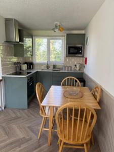 a kitchen with a wooden table and chairs at 85 Strawberry Hill Hayle in Hayle