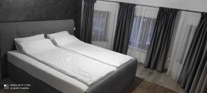Ένα ή περισσότερα κρεβάτια σε δωμάτιο στο Deacu's Home