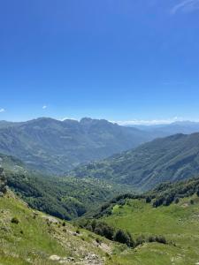 a view of a valley with mountains in the distance at Djedov do 2 in Žabljak