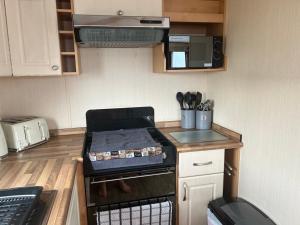 a kitchen with a stove with a box on it at 353 northfield in Skipsea