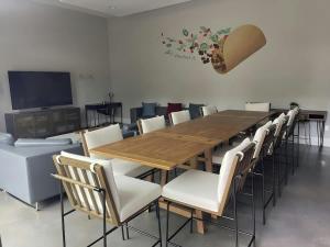 a conference room with a wooden table and chairs at Modern 2-Home Private Oasis w Pool Hot Tub in DT in Austin +37 photos