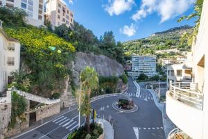 a street in a city with a mountain at Monte carlo riviera in Beausoleil