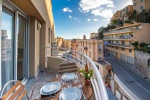 a balcony with a table and a view of a city at Monte carlo riviera in Beausoleil +14 photos