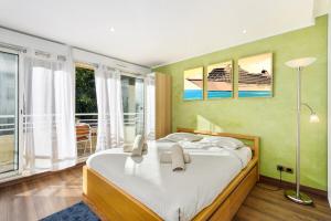 a bedroom with a large bed and a balcony at Monte carlo riviera in Beausoleil