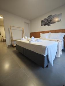 a bedroom with a large bed with white sheets at Flat Moderno Asa Norte - Alvorada Suites 205 in Brasilia