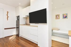 a living room with a flat screen tv on a wall at Monte carlo riviera in Beausoleil
