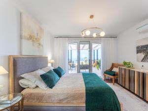 a bedroom with a large bed with a green blanket at GS Luxury Ocean View Villa with Heated Pool by Golf in Adeje +37 photos