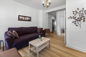 a living room with a couch and a table at Cozy Retreat in Historic Indianapolis Neighborhood Close to Downtown in Indianapolis