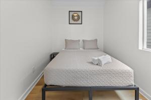 a bed in a white room with a mattress at Cozy Retreat in Historic Indianapolis Neighborhood Close to Downtown in Indianapolis