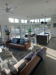 a living room with two couches and a table at Game Day Penthouse Steps from UT Sports in Austin