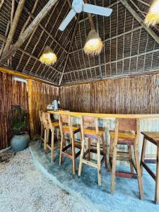a dining room with a table and chairs at Compass Hostel in Nungwi
