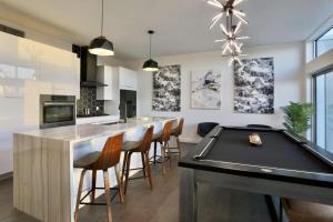 a kitchen with a bar with a pool table at Tailgate Penthouse 2 Blocks from UT Stadium in Austin