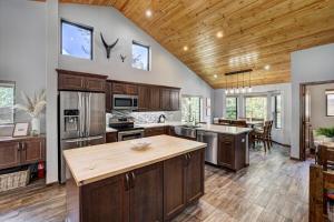 a large kitchen with wooden cabinets and a kitchen island at Luxury Modern Townhome-Private Hot Tub-In Town in Breckenridge