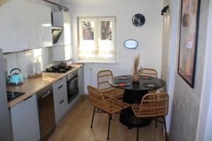 a small kitchen with a table and chairs in it at AP Apartment's Rodzinny in Wałbrzych +10 photos