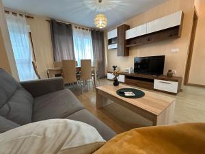 a living room with a couch and a tv and a table at Alicante super center by Sunset in Alicante