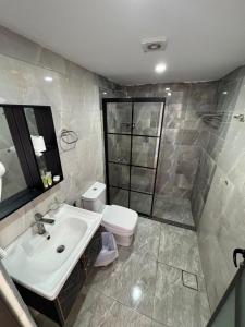 a bathroom with a sink and a toilet at Wadi Rum Hala camp in Wadi Rum