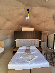 a bedroom with a large bed with a star on it at Wadi Rum Hala camp in Wadi Rum