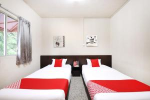 Postel nebo postele na pokoji v ubytování OYO 507 Aikka Hotel