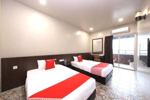 Postel nebo postele na pokoji v ubytování OYO 507 Aikka Hotel