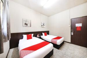Postel nebo postele na pokoji v ubytování OYO 507 Aikka Hotel