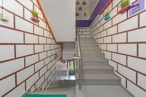 a stairwell in a building with stairs with potted plants at Hotel O Purple Town in Sekinchan