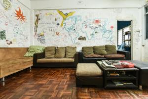a living room with two couches and a map on the wall at Hotel O Kuantan Backpackers in Kuantan