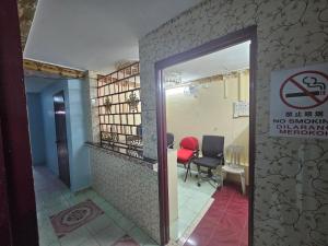 a room with a no smoking sign and a red chair at Hotel O Bintang Inns in Rawang