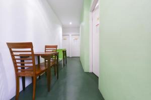 a dining room with chairs and a table in a room at Hotel O Kuantan Backpackers in Kuantan +26 photos