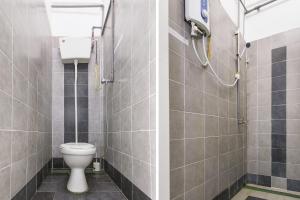 a bathroom with a toilet and a shower at Hotel O Kuantan Backpackers in Kuantan