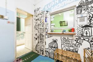 a room with a wall covered in graffiti at Hotel O Kuantan Backpackers in Kuantan