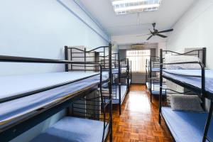 a row of bunk beds in a room at Hotel O Kuantan Backpackers in Kuantan