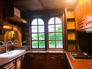a kitchen with a sink and two windows in it at Hotel O I.villa Inn in Kuala Lumpur +53 photos