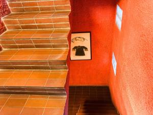 a stairway with a picture on the wall at Hotel O I.villa Inn in Kuala Lumpur