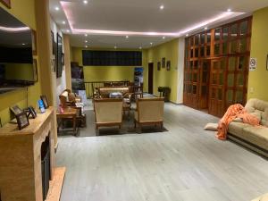 a living room with a couch and a table at Hotel Y Villas el Encuentro in Tlatlauquitepec