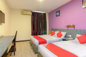 Postel nebo postele na pokoji v ubytování Super OYO 43930 Hotel Esplanade